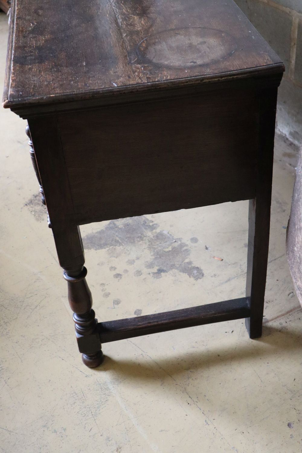 A late 17th century style oak dresser base fitted three geometrically moulded frieze drawers, width 182cm depth 48cm height 75cm